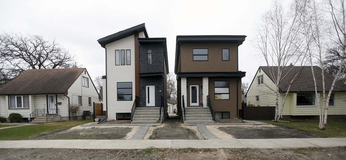 Photo of two new houses in old neighbourhood
